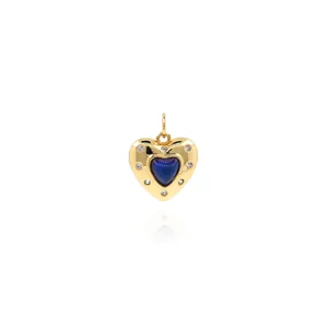 Macro shot of 18K gold plated heart pendant with blue center and sparkling zircons