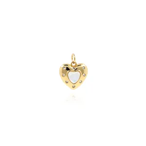 Macro detail of 18K gold plated heart pendant with white center and zircon border