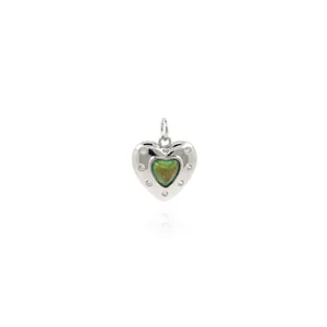 Macro shot of 18K gold plated heart pendant with green enamel and sparkling zircons