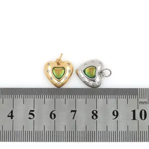 Detail of 18mm heart charms with gradient resin and cubic zirconia inlay next to a ruler