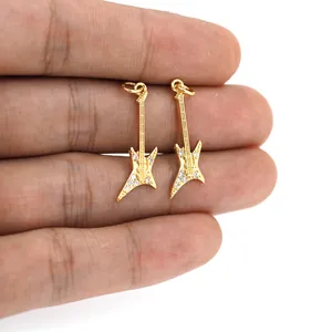 Macro shot of 18K gold plated mini guitar pendants with micro-pave cubic zirconia accents