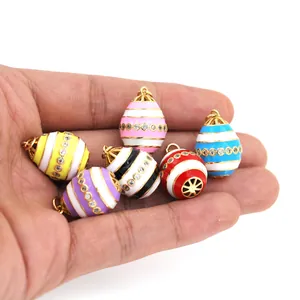 Detailed view of Faberge style colorful enamel egg pendants with cubic zirconia inlay