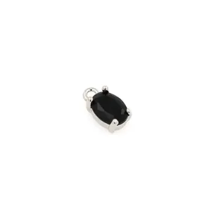 Detailed view of an oval black zircon pendant with silver claw setting for jewelry DIY