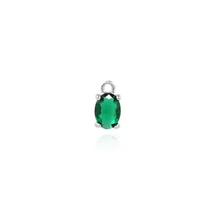 Detail of oval emerald green gemstone pendant with 18K gold plated zircon setting