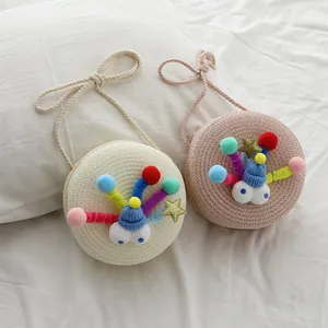 Lindos bolsos bandolera redondos de paja para niñas con ojos de monstruo y dijes