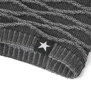 Close-up of knit texture with cable pattern and star logo patch on winter beanie