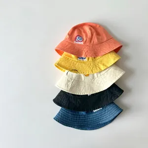 Detail view of cotton sun hats in five vintage colors with letter print for children