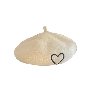 Classic apricot wool beret for kids featuring a minimalist black embroidered heart design