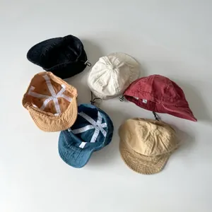 Detail view of colorful vintage soft-top baseball caps with adjustable drawstrings for kids