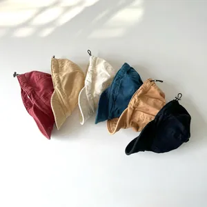 Detail of adjustable cotton bucket hats in six colors featuring drawstring toggle design