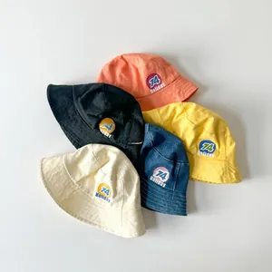Detail shot of multi-color cotton bucket hats with retro 74 Holiday letter embroidery