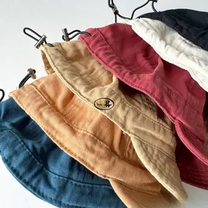 Detail of colorful corduroy bucket hats with adjustable drawstrings in multiple colors