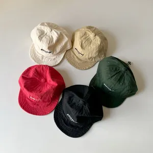 Detail showing five colors of cotton kids baseball caps with Discover embroidery