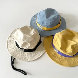 Detail view of colorful nylon kids bucket hats with adjustable windproof straps