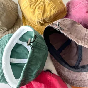 Dettaglio di berretti retrò in cotone lavato con coulisse regolabile e colori assortiti