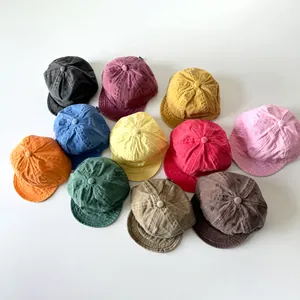 Flat lay of vintage washed cotton soft brim baseball caps for toddlers in eleven colors