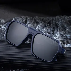 Modern navy square polarized sunglasses for men displayed on a textured stone base