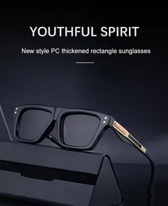 Detail of square black sunglasses with thick frames and golden metal temple decor
