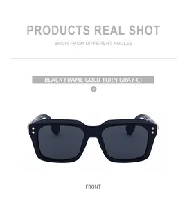 Front view of black square frame sunglasses with golden rivets and dark grey lenses