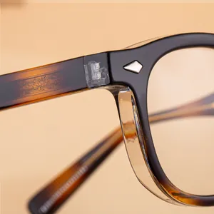 Detail of square sunglasses hinge with silver rivets and tortoiseshell temples
