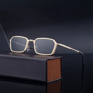 Retro square metal sunglasses with gold carved frame and leather case on reflective base