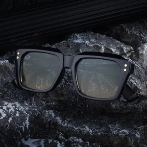 Men's square oversized sunglasses in glossy black frame on a dark stone texture background