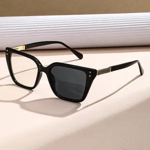 Stylish black cat-eye photochromic sunglasses with gold hinges and glitter detail