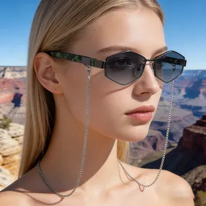 Polygonal sunglasses with silver chain and marble temples worn in scenic outdoor canyon