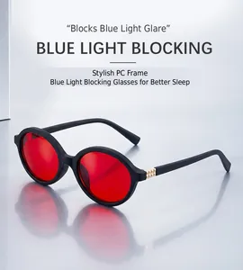 Close-up of stylish PC frame glasses with red lenses and gold metal temple accents