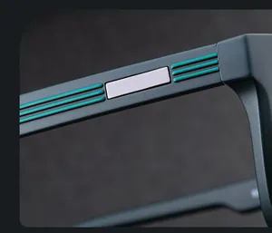 Macro view of matte black sunglasses temples with silver metal and mint green linear accents
