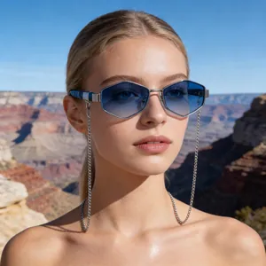Close-up of hexagonal sunglasses with blue gradient lenses and decorative silver chain