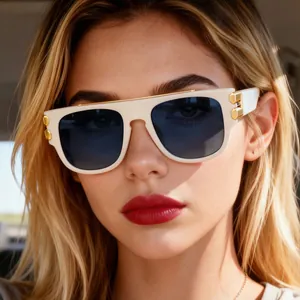 Close-up of square cream sunglasses with dark blue lenses and gold metal temple details