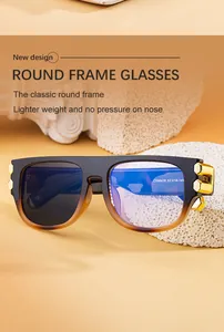 Detail of square photochromic sunglasses with gold hexagonal metal accents on the frame