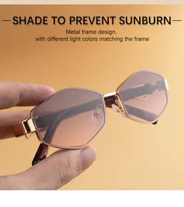 Detail of trendy geometric sunglasses with golden metal frame and gradient lenses