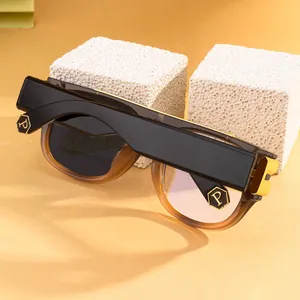 Detail of square photochromic sunglasses with black and amber frames and silver P logo