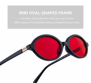 Detail of trendy oval sunglasses with red lenses and golden pyramid stud decorations