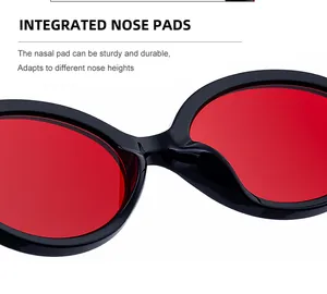 Close-up of integrated nose pads and red lenses on professional black swimming goggles
