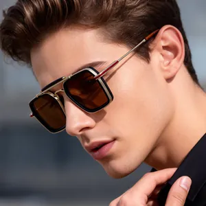 Close-up of retro square sunglasses featuring black and gold frames with brown lenses