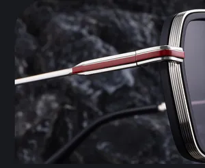 Detail view of square sunglasses with silver metal temples and red accent line