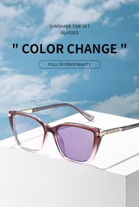 Cat-eye photochromic sunglasses with gradient brown frame and rhinestone detail on stones