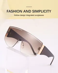 Detail view of oversized rimless sunglasses featuring brown gradient lenses and hollow design