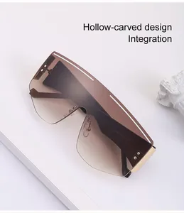Detail of oversized shield sunglasses with gradient lenses and hollow-carved top line
