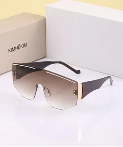 Detail of oversized shield sunglasses with gradient lenses and gold metal accents