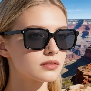 Detail shot of black square frame sunglasses with silver rivets on a male model