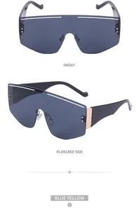 Front and 45-degree side macro view of oversized blue shield sunglasses with gold metal trim