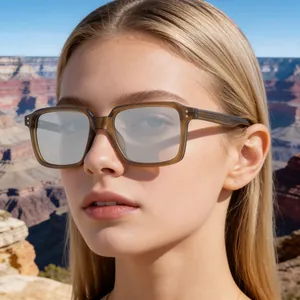 Close-up of vintage translucent square sunglasses with metallic rivets on a male model