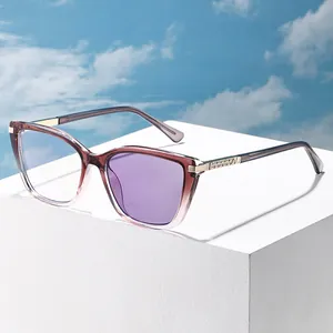 Modern gradient cat-eye sunglasses with diamond-studded gold metal accents on white base