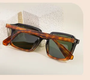 Detail of square sunglasses with black and tortoise frame and textured temples