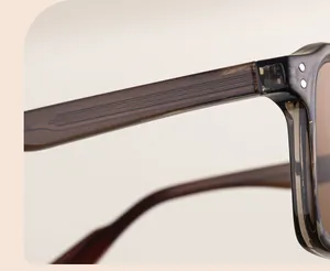 Macro detail of translucent amber sunglasses showing metal core and double rivets