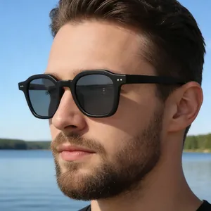 Men's square frame sunglasses with black matte finish and dark grey lenses outdoors